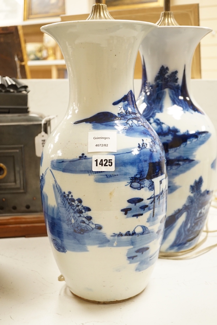 A pair of 20th century Chinese blue and white porcelain table lamps, 43 cms high excluding light fitting.